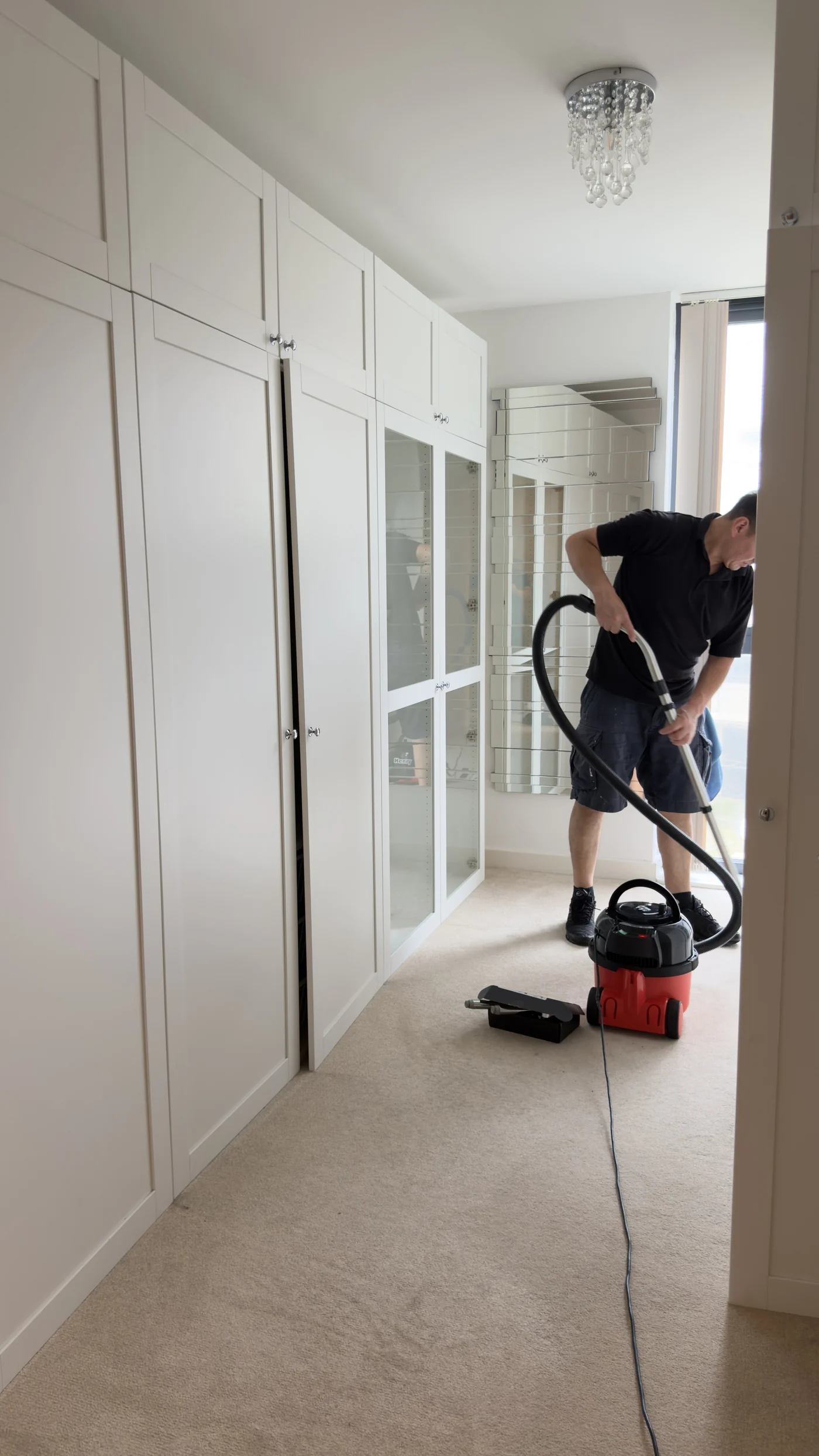 Cleanfinity operative vacuuming a walk-in wardrobe, Saltdean, Brighton