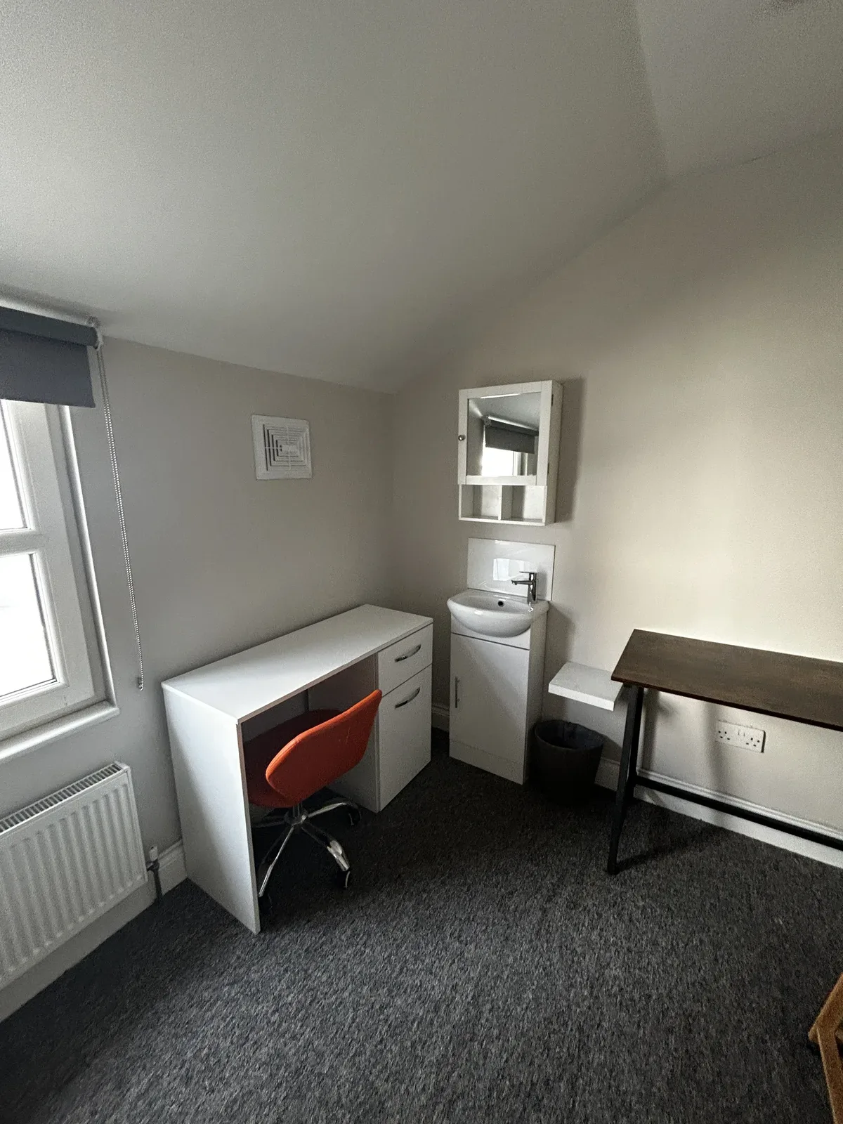 Student bedroom with basin after clean, seven dials