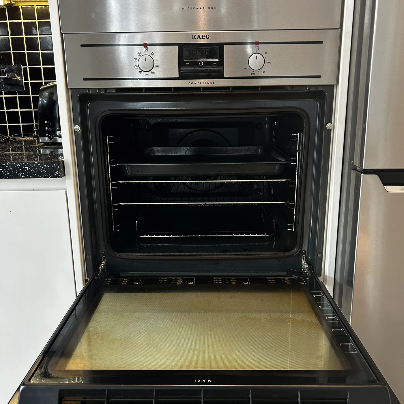 Oven interior on arrival — the door glass is the giveaway
